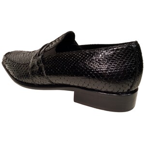 May include: Black leather slip-on shoes with a snakeskin pattern.
