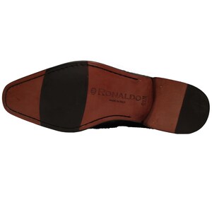 May include: The bottom of a black leather shoe with a brown leather sole. The sole is labeled "RONALDO MADE IN ITALY" and "9 1/2 M".