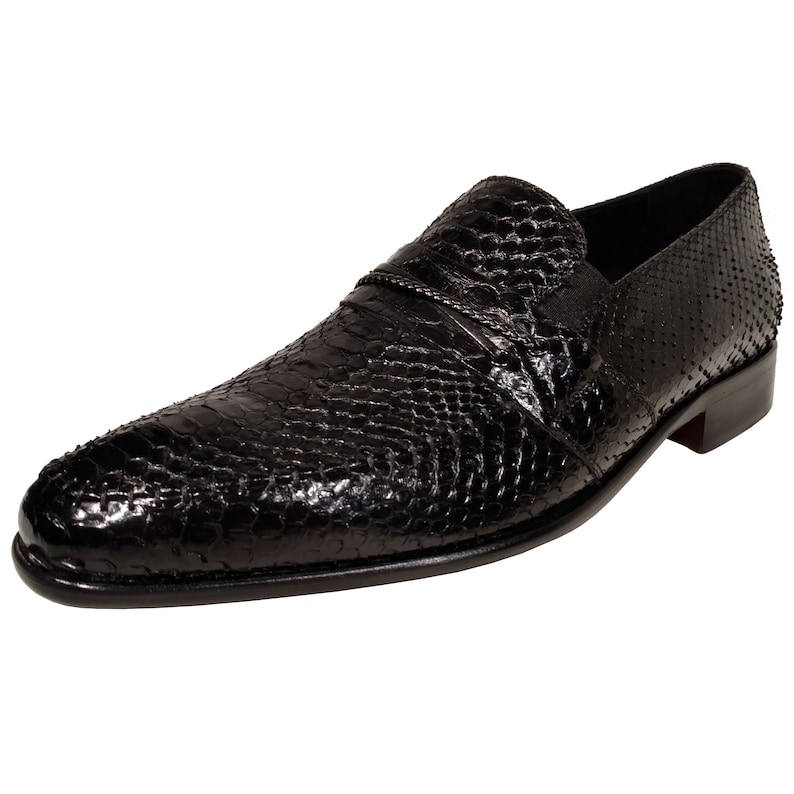 May include: Black leather slip-on shoes with a snakeskin pattern.