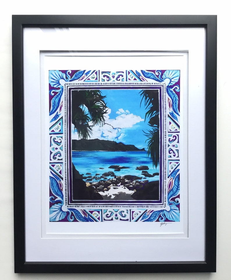 May include: A framed print of a tropical beach scene with palm trees, blue water, and a rocky shore. The print is surrounded by a decorative border with blue, purple, and white geometric patterns.