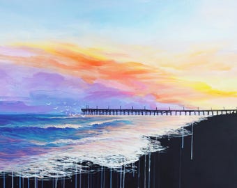 May include: A painting of a pier extending into the ocean at sunset. The sky is a vibrant mix of orange, yellow, purple, and blue. The water is a deep blue with white foamy waves crashing on the shore.