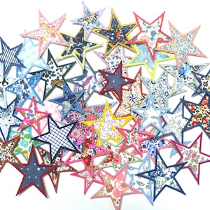 May include: A collection of colourful fabric star-shaped patches. The stars are made of various fabrics with floral and geometric patterns. The stars are arranged in a circular pattern.