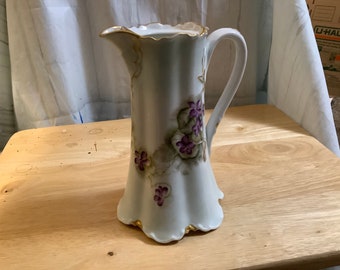 Beautiful Haviland Pitcher, Purple Violets and Green Leaves on a white background trimmed in Gold.