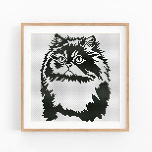 May include: A square cross-stitch pattern featuring a black and white graphic of a fluffy cat with long fur, large eyes, and a distinct facial expression, presented within a light-colored wooden frame against a plain white background.