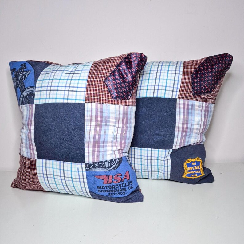 May include: Two blue and red patchwork pillow covers with a motorcycle design and the text "BSA Motorcycles Birmingham, UK Est. 1903" and "The Vintage Motorcycle Club"