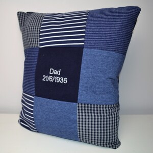 May include: A blue and white patchwork pillow with the text "Dad 21/6/1936" embroidered on the front.