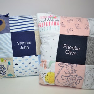 May include: Two personalized baby pillows, one blue and one pink, with a patchwork design. The blue pillow has a bear applique and the text "Samuel John". The pink pillow has the text "Phoebe Olive".