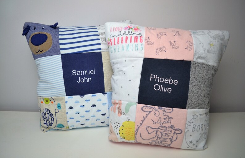 May include: Two personalized baby pillows, one blue and one pink, with a patchwork design. The blue pillow has a bear applique and the text "Samuel John". The pink pillow has the text "Phoebe Olive".