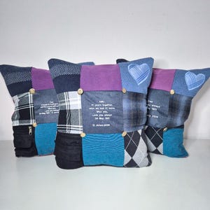 May include: Three blue and purple patchwork pillow covers with embroidered hearts and personalized messages. The messages include "Dad Cricket & Football is not the same without you Miss you always 04 May 1951 12 January 2024" and "AMU 51 years together which we had 51 more Miss you Love you always 04 May 1951 12 January 2024".