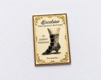 May include: A rectangular card labeled Excelsior Fine Quality Buttons with 10 patent fasteners, featuring a vintage-style illustration of a boot. The card has a cream background, gold decorative borders, and black text detailing the product.