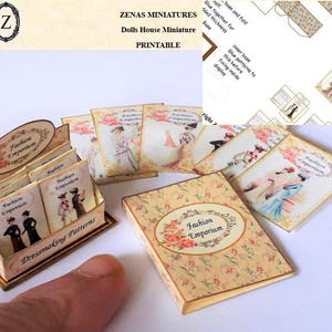 May include: Miniature "Fashion Emporium" books and display box. The books feature illustrations of vintage fashion and the text "Fashion Emporium" and "Dressmaking Patterns". The display box is beige with a floral pattern.