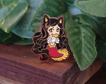 May include: A gold-tone enamel pin featuring a cartoon mermaid with long black hair, wearing a white shirt and a red tail. The mermaid is holding a piece of food in her mouth.
