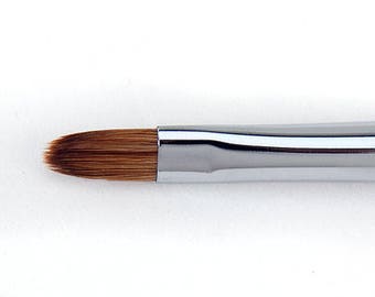 May include: A makeup brush with a rounded, oval-shaped brush head. The bristles are brown. The brush has a silver ferrule and a light tan handle. The brush is designed for applying makeup.