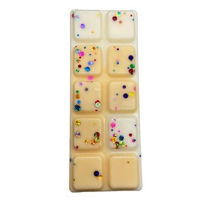 May include: A wax melt set with eight individual squares. The wax melts are a light yellow color and have colorful glitter embedded in them.