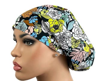 May include: A floral print bouffant scrub cap featuring a black background with colorful flowers in shades of yellow, white, pink, blue, and orange. The cap is designed to cover the hair and is likely used in medical or beauty settings.