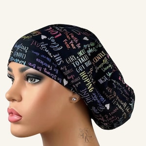 May include: A black scrub cap featuring a colorful, multi-font typographic print with motivational phrases including "Girl, you totally got this," "Be strong," "Be fearless," "Shine," "Love," and "Hoping," interspersed with small white hearts.