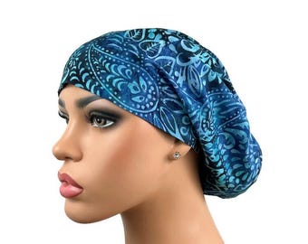 May include: A blue and black patterned surgical scrub hat with a paisley design.