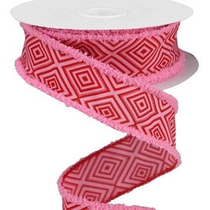 May include: Pink and red ribbon with a geometric diamond pattern and a frayed edge.