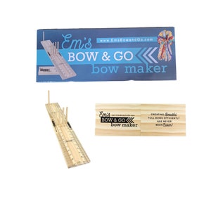 May include: A wooden bow maker tool with a ruler and pegs for creating bows. The tool is labeled "Em's BOW & GO bow maker" and "www.EmsBowandGo.com".