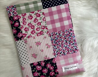 May include: A patchwork fabric pouch with a pink and white gingham pattern, floral prints, and polka dots. The pouch has a white label with the text "Always September".