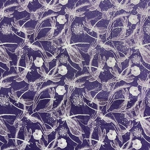 May include: Purple fabric with a white dragonfly pattern. The fabric has a subtle sparkle.