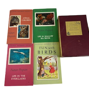 May include: Five vintage National Audubon Society nature program books with colorful covers featuring animals and nature scenes. The books are titled "Nature Program", "Animal Children", "Nature Program Life in Shallow Sea Water", "Nature Program Life in the Everglades", and "Fun with Birds".