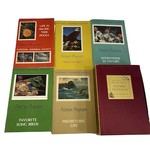 May include: A set of six vintage National Audubon Society nature program books with colorful covers featuring birds, flowers, and other wildlife. The titles include "Life in Pacific Tide Pools", "Birds of Prey", "Inventions in Nature", "Favorite Song Birds", "Prehistoric Life", and "Nature Program".