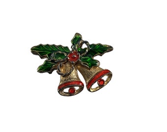 May include: Gold-tone Christmas bells with red and green enamel, decorated with holly leaves and a red bow.