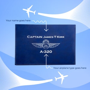 May include: A blue leather logbook with the text "CAPTAIN JAMES T KIRK" and "A-320" in white. A white airplane wing with a star and the text "Your Airline" is above the text "A-320".