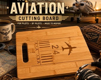 May include: A rectangular bamboo cutting board featuring a runway design and the text "Runway 24 Aviation Cutting Board". The board has a handle and an airplane silhouette. Other items include a mug, sunglasses, and a keychain.