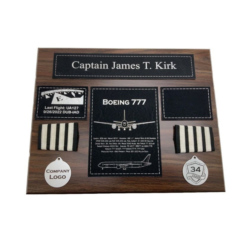 May include: A wooden plaque with a black leather background, honoring a pilot named Captain James T. Kirk. The plaque includes a Boeing 777 aircraft silhouette, a pilot's wings, a company logo, and a 34-year service award.