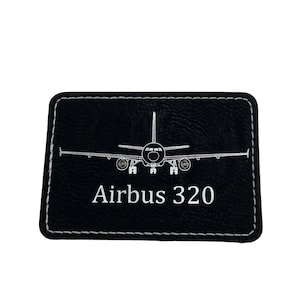 May include: Black leather patch with white stitching. The patch features a white outline of an Airbus 320 airplane and the text "Airbus 320".