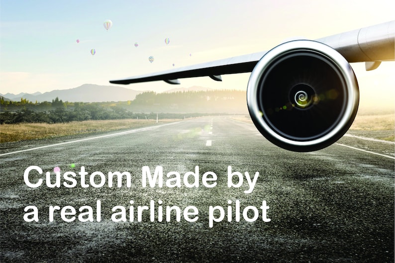May include: A close-up of an airplane engine on a runway with a blue sky and white clouds in the background. The text "Custom Made by a real airline pilot" is in the foreground.