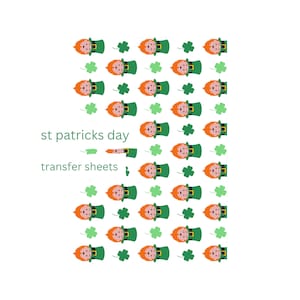 May include: A sheet of transfer paper with a repeating pattern of leprechauns wearing green hats and holding shamrocks. The text "st patricks day transfer sheets" is printed on the sheet.