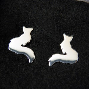 May include: A pair of silver fox silhouette earrings. The earrings are small and delicate, and they are perfect for adding a touch of whimsy to any outfit.