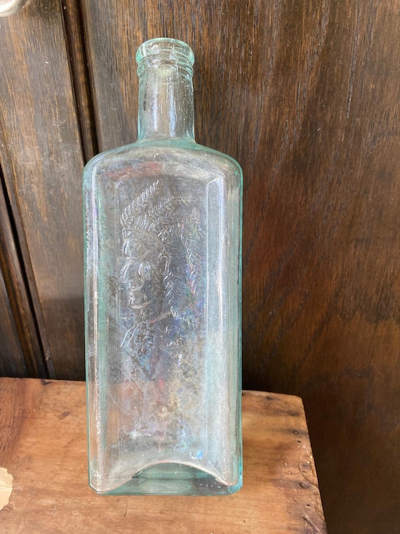 Indian Water Bottle. Green Healy & Bigelow Indian Head Bottle. Indian's Agwa. Old Native American Bottle