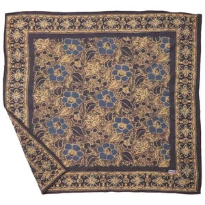 May include: Square patterned scarf with a floral design. The scarf features blue flowers and tan leaves on a tan background, framed by a dark blue border with a geometric pattern. The scarf is folded, showing a corner.