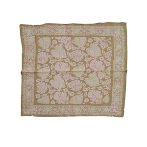May include: A square bandana featuring a muted olive green background with a repeating pattern of light pink monstera leaves and small flowers. The fabric is framed by a decorative border with a geometric diamond and vine motif in white.