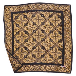 May include: Square, black and gold patterned bandana. The bandana features a repeating floral and geometric design. The border is black with a repeating diamond pattern. The center of the bandana is gold with a black floral pattern.
