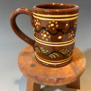 Redware, sliptrailed mug,black