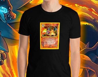 May include: A black t-shirt with a vintage Pokemon card featuring Charizard on the front. The card is surrounded by a fiery orange background.