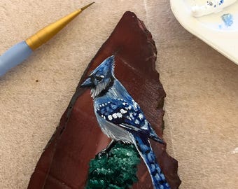 Hand painted blue jay on natural red rock!