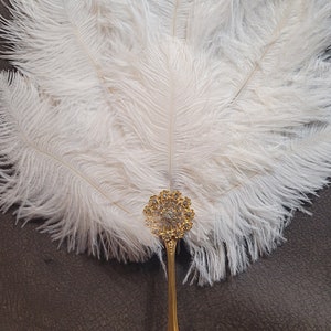 Medium jeweled white ostrich feathers and gold stainless Steel handle