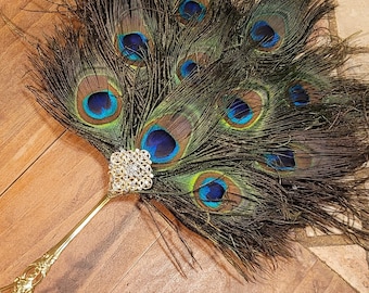 Medium jeweled peacock feathers and gold stainless Steel handle super lightweight