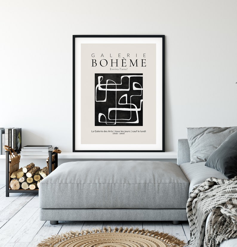 May include: A black and white minimalist art print with the text "GALERIE BOHEME" and "Evviva Parte" in a black frame. The print features a black background with white abstract lines and shapes. The text "La Galerie des Arts | tous les jours | sauf le lundi 1000-1800" is at the bottom of the print.