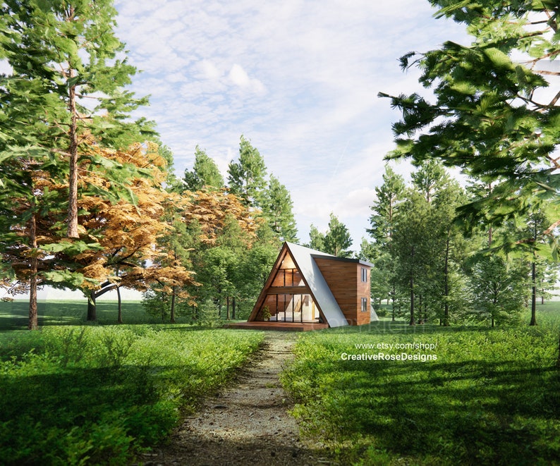 May include: A wooden A-frame cabin nestled in a forest clearing. The cabin has large windows and a path leading up to the front door. The trees surrounding the cabin are green and lush.