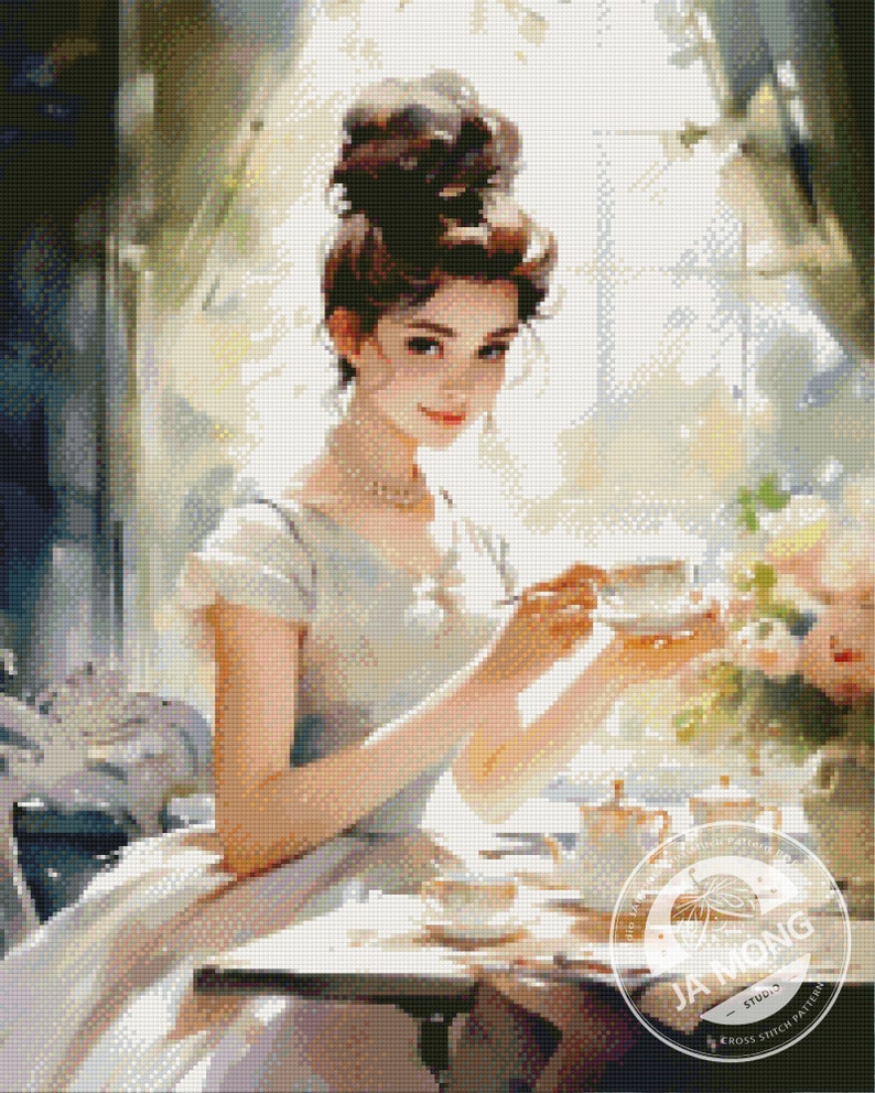 May include: A woman in a light blue dress sits at a table with a cup of tea and a teapot. She is wearing a pearl necklace and has her hair pulled back in a bun. The table is set with a white tablecloth and a floral arrangement.
