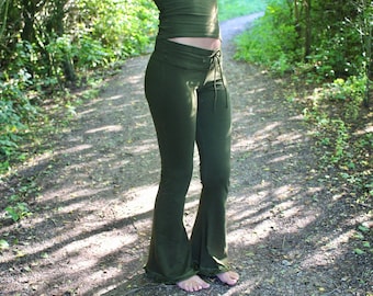 May include: Olive green fitted pants with a flared leg silhouette, featuring a wide waistband with a drawstring tie closure. The pants are paired with a matching olive green fitted top that leaves the midriff area exposed.
