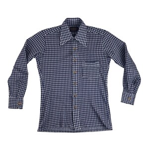 May include: A long-sleeved button-down shirt with a navy blue background and a repeating white oval pattern. The shirt has a pointed collar, a chest pocket, and buttoned cuffs. The shirt is made of a lightweight fabric.