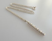 Silver and zirconia line pendant on a Danish chain necklace